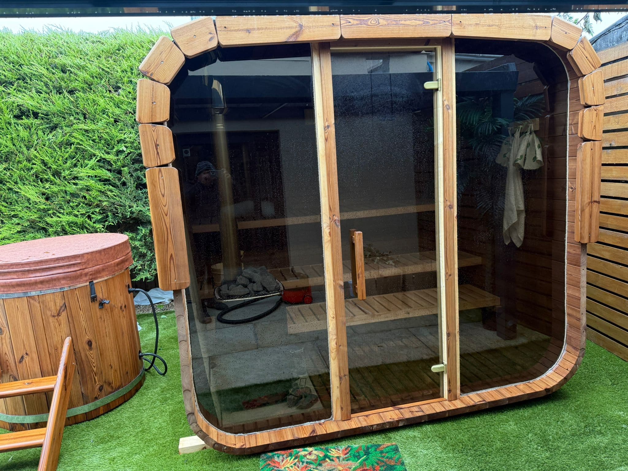 Outdoor panoramic barrel sauna evening lighting