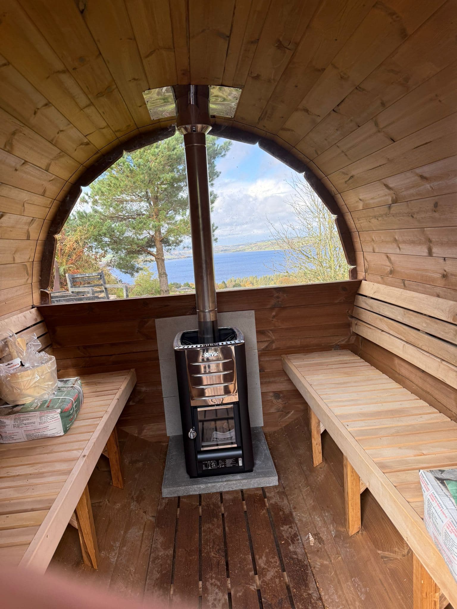 Barrel sauna interior with wood-burning stove