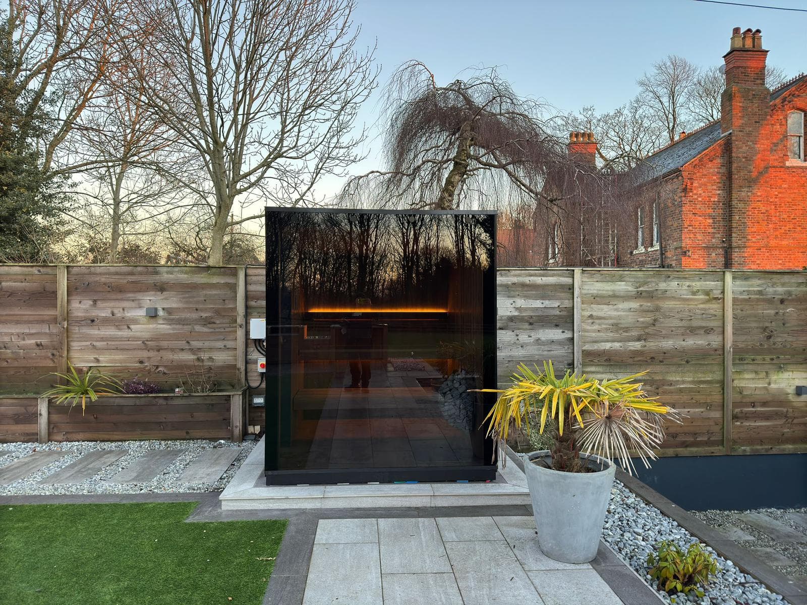 High-end backyard sauna with panoramic glass wall