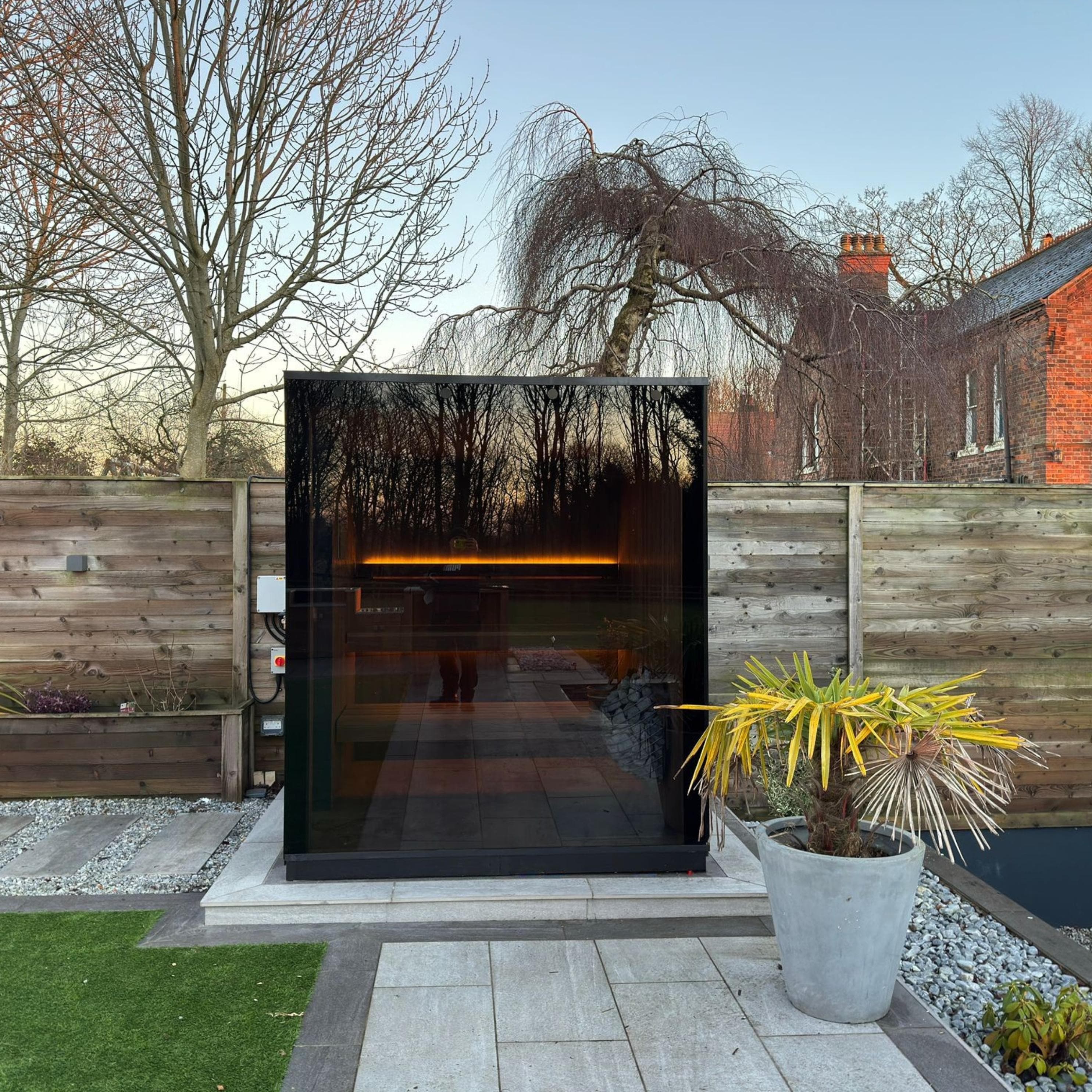 Modern wooden cube sauna with panoramic glass front